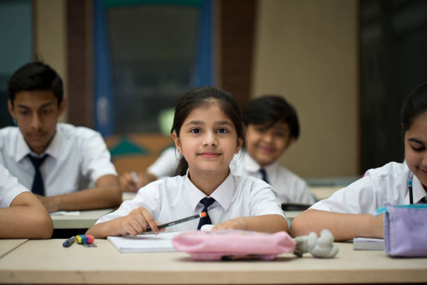 Group of students studying book at classroom