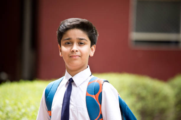 Portrait of Indian schoolboy standing at school campus